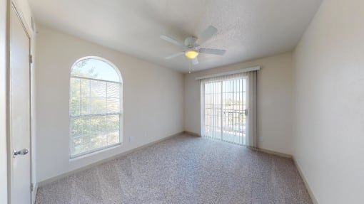 a living room with a ceiling fan and a window