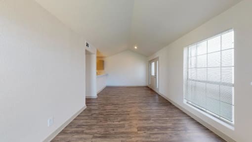 a spacious living room with a large window