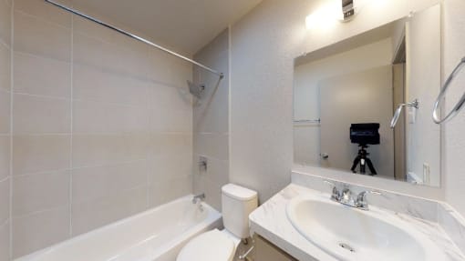 a white bathroom with a sink and a mirror