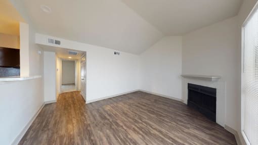 a living room with vinyl hardwood floors, fireplace and breakfast bar