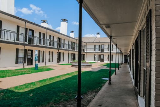 a view of a courtyard in a building at an apartment complex