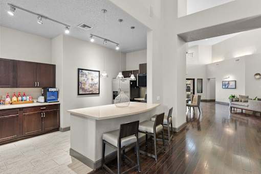 A kitchen with a white island and brown cabinets.