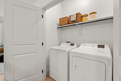 A white laundry room with a washer and dryer.