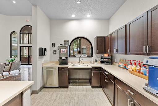 A kitchen with brown cabinets and a white counter.