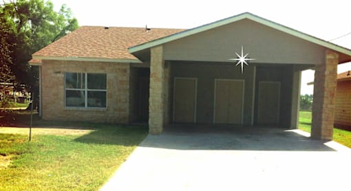 A house with a brown roof and a garage.