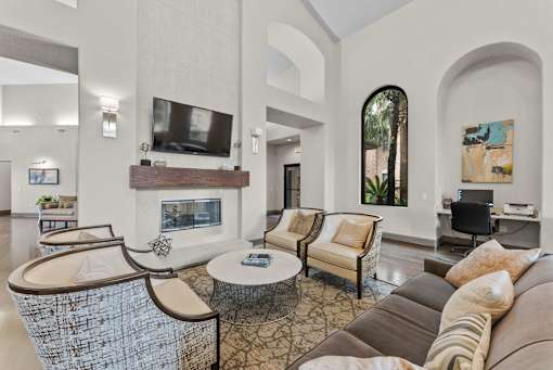 A living room with a fireplace and a television.