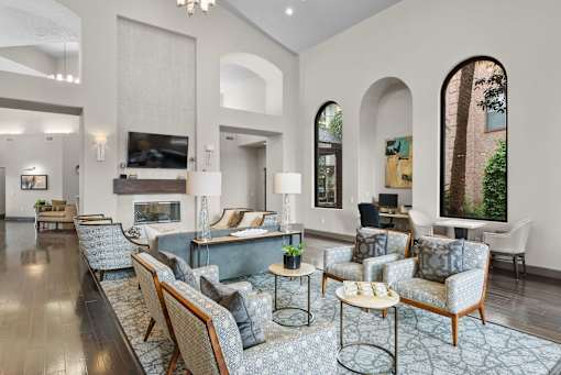 A living room with a grey carpet and furniture.