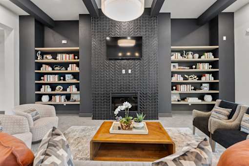 A modern living room with a fireplace and a flat screen TV mounted above it.
