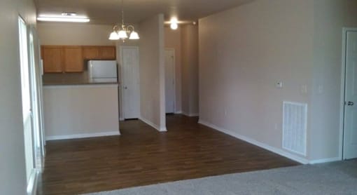A room with wooden floors and white walls.