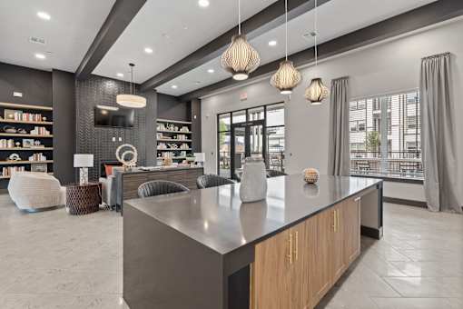 A modern reception area with a dark grey reception desk and a large flat screen TV mounted on the wall.