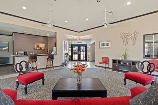 A living room with a red couch and a black coffee table.