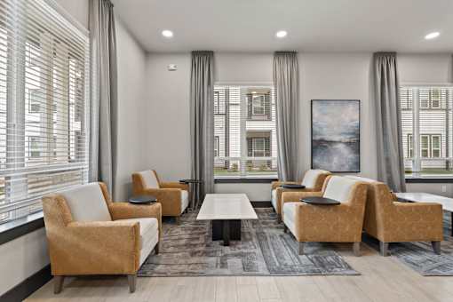 A living room with a large window and a view of a building.