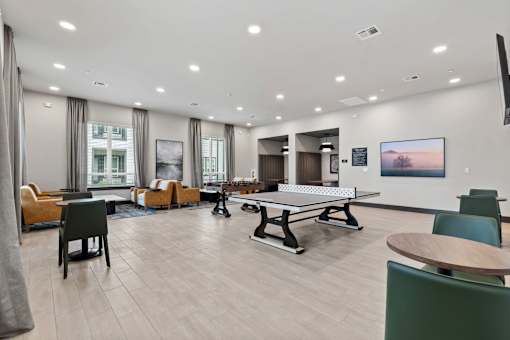 A spacious room with a table and chairs.