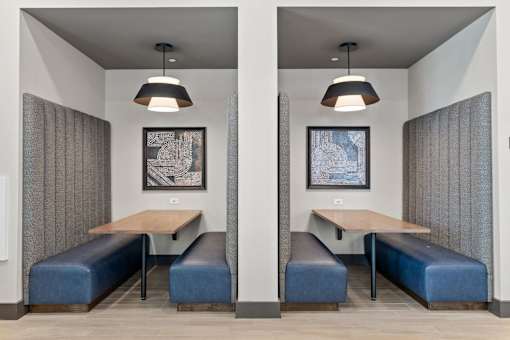 A room with two benches and two tables.