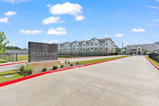 A sign that says Tapestry in front of some buildings.