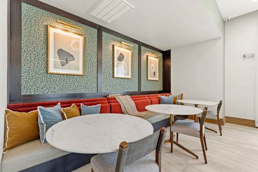 A dining area with a white table and chairs.