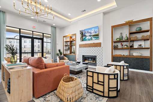 A living room with a fireplace and a TV on the wall.