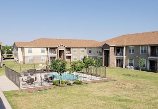 Apartment complex with a pool in the middle.