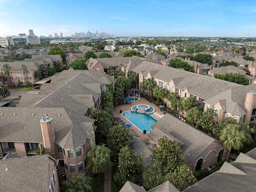 A bird's eye view of a residential area with houses and a swimming pool.
