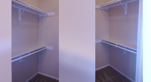 A white closet with a shelf and a door.