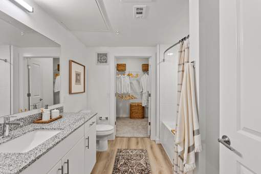 A bathroom with a white sink and a white toilet.
