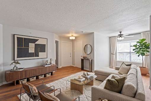 A living room with a couch, chairs, and a coffee table.