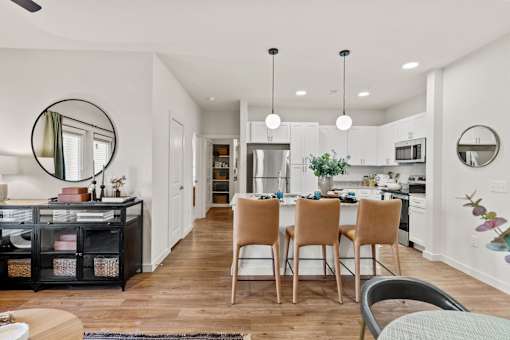 A modern kitchen with wooden floors and a central island.