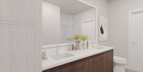 A bathroom with a white countertop and a white sink. at Enclave on Ross Apartments, Del Valle, Texas