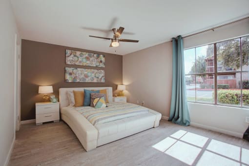 a bedroom with a bed and a ceiling fan