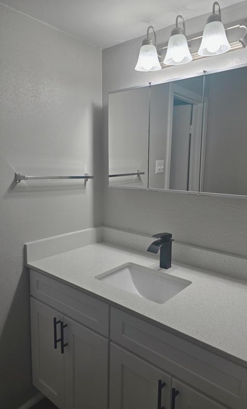 an empty bathroom with a sink and a mirror