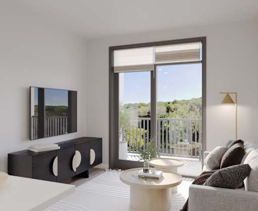 A modern living room with a flat screen TV, a white sofa, and a large window with a view of the outdoors. at Enclave on Ross Apartments, Del Valle78617
