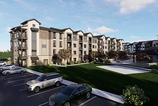 A row of modern apartment buildings with cars parked in front. at Enclave on Ross Apartments, Del Valle, TX, 78617