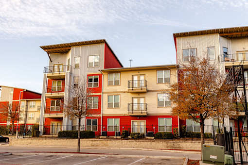 Apartment building with red and beige facades.