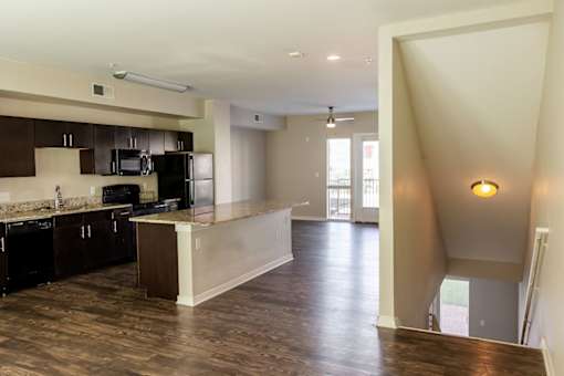 A kitchen with dark wood cabinets and a counter top.