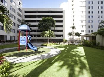 a playground with a slide in front of a building