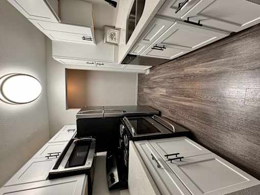 Kitchen with hardwood floors and white cabinets