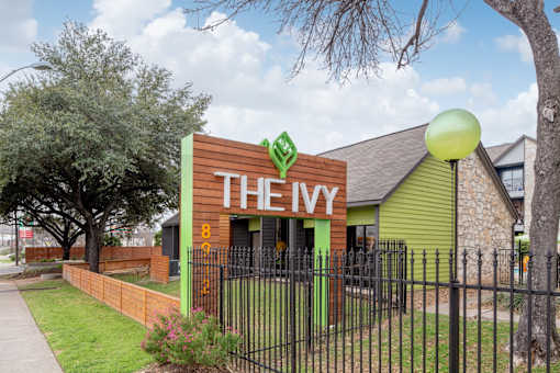 A green and brown building with THEY on the front.