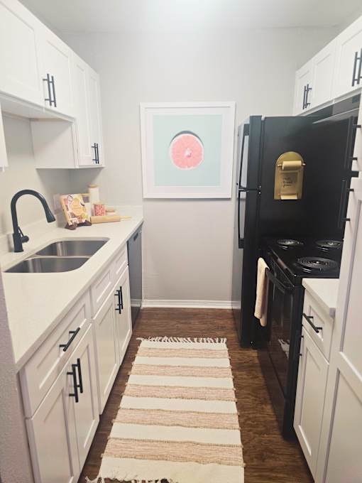 kitchen with white cabinets and a black refrigerator