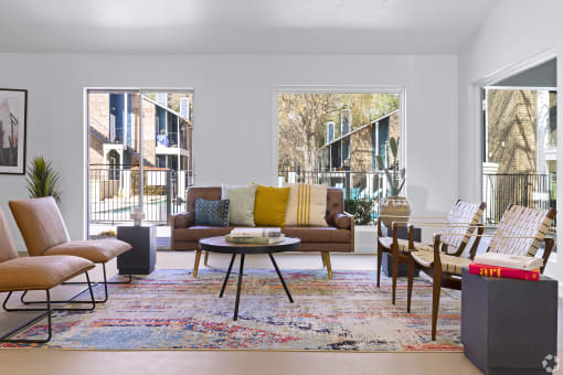 a living room with couches chairs and a rug