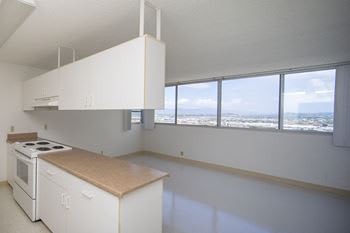 a kitchen with a stove top oven next to a window