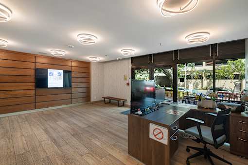 A room with a wooden desk and a no entry sign on it.