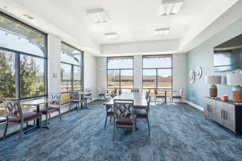 A spacious room with a dining table and chairs.