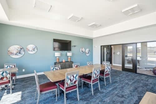 A conference room with a long table and chairs.
