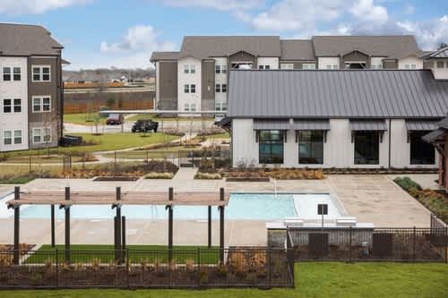 A large house with a pool in the backyard.
