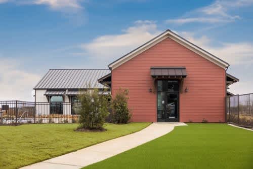 A red building with a black door and windows.