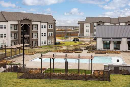 A large building with a pool in front of it.