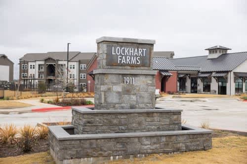 A stone monument with Lockhart Farms 1911 engraved on it.