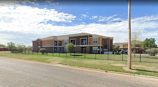 A building with a black fence in front of it.