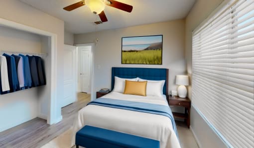 a bedroom with a large bed and a ceiling fan