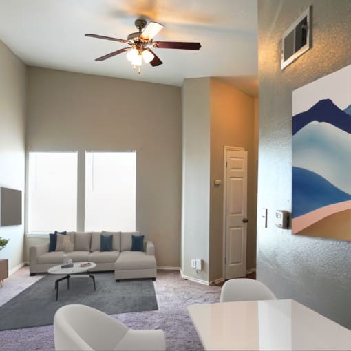 a living room with a couch and a ceiling fan